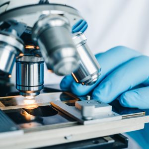 Close-up shot of microscope with metal lens at laboratory.